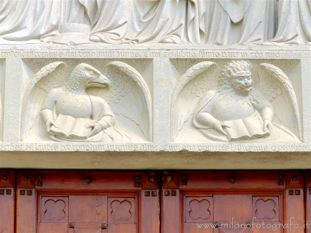 Castiglione Olona (Varese, Italy) - Symbols of Saint John and Saint Mark on the architrave of the portal of the Collegiate Church of Saints Stephen and Lawrence